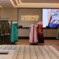 NEXT sales rise but UK outlook softens as Wolfson warns against tax rises